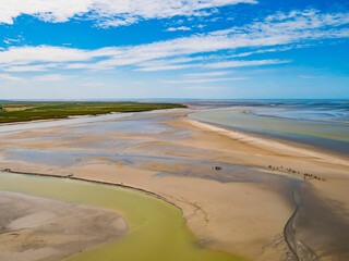 Le Mont Saint Michel, impressive view of the colourful sand flats surrounding the famous abbey during low tide, Normandy, Northern France
