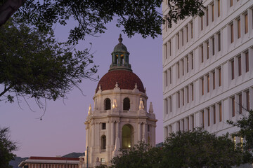 Naklejka premium Image of the main tower of the Pasadena City Hall and a juxtaposed modern office building shown at dusk.