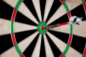 Darts. Dartboard. Dart in bullseye. Dart in the center.