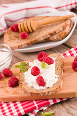 Rye bread with cottage cheese and raspberries.