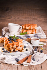 Waffles with blueberries and whipped cream.