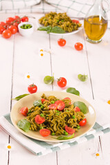 Fusilli pasta with cherry tomatoes and peas.