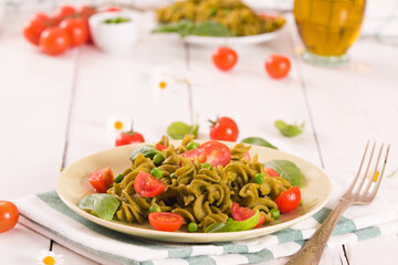 Fusilli pasta with cherry tomatoes and peas.