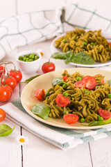Fusilli pasta with cherry tomatoes and peas.