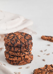 Oatmeal cookies with chocolate and seeds on a white background. Breakfast concept. Side view.