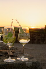 Hugo im Sonnenuntergang, Cocktail mit Eis und Limetten auf der Terrasse zum Sommerabend