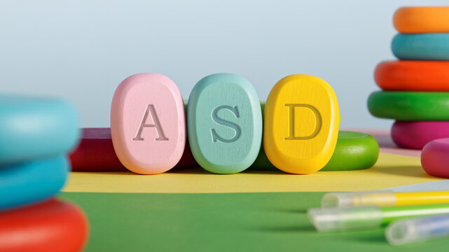 Letters ASD written on colorful toy blocks. Autism Spectrum Disorder concept.