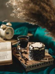 A wooden tray with a fragrant coffee candle and coffee on the bed. Hygge concept. Relaxation atmosphere. Luxurious lifestyle.