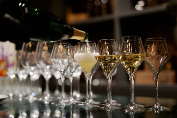 bartender pouring champagne in the evening