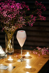beautiful pink cocktail with colored sprinkling in the night bar