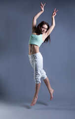 Naklejka premium beauty girl dance on grey background. person jumping, flying in the air
