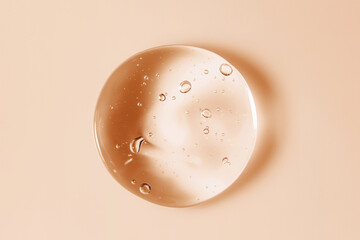 Cosmetic serum gel beauty oil drop on color background. Skin care product droplet with bubbles...