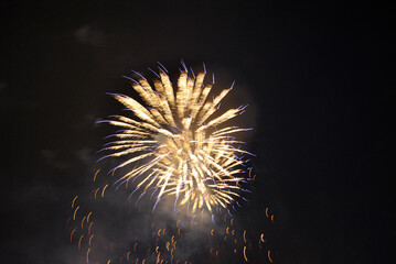 Colorful salute, great explodes in different colors in the night sky, beautifully dissolving in the air.