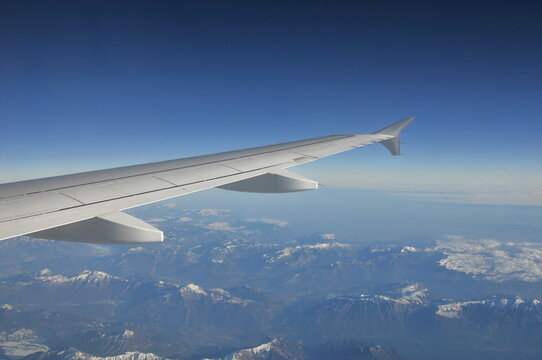 Airplane's wing during a flight over the Alps