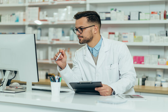 Portrait of a handsome pharmacist working in a pharmacy
