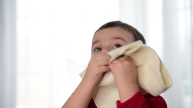 Close-up of a child wiping his mouth with a napkin
