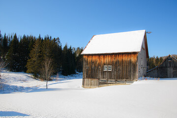 Old barn in a winter countryside landscape in Quebec, Canada
