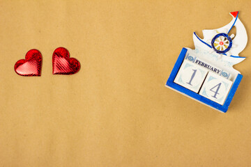 red heart and calerdar on a blue background with a place for the text, top view, Valentine's Day is the holiday of lovers.