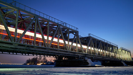 Fototapeta na wymiar Train movement across the Railway bridge in Voronezh in winter