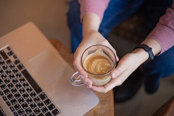 Young caucasian woman working via laptop at the cafeteria