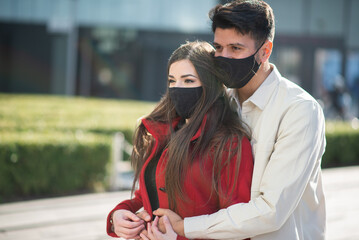 Couple walking in a city during coronavirus pandemic