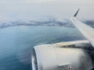View from the porthole on the wing of the aircraft when approaching the landing in inclement weather