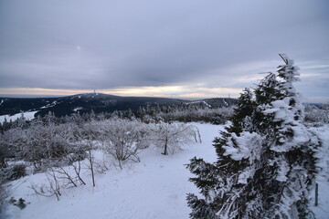 snowy view on Klínovec/Keilberg from top of Fichtelberg the highest mountain in middle Germany - winter landscape