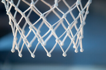 Empty swooshing basketball net closeup with blue background. Horizontal sport theme poster, greeting cards, headers, website and app
