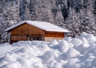  Generic wooden house in the woods in the middle of a snowy winter landscape in Engadine, Switzerland