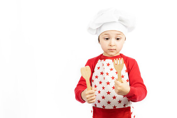 Child chef looking at kitchen utensils on white background