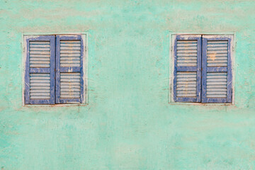 Colorful background of turquoise wall and blue windows typical of nubian village in aswan, egypt
