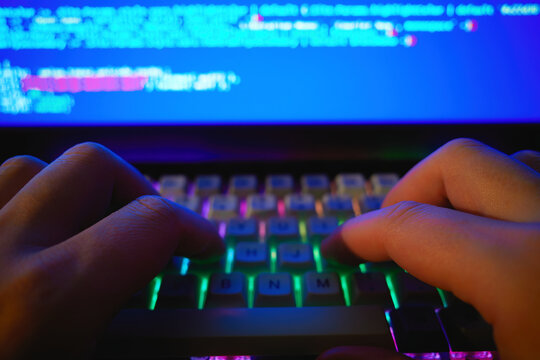 Hacker fingers on computer keyboard backdrop