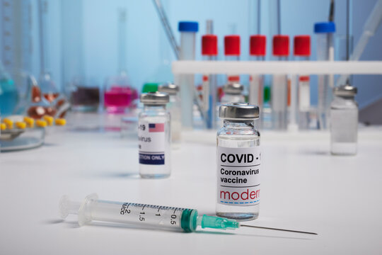 Krasnoyarsk, Russia. April 29, 2021. Covid-19 Moderna vaccine vial and inoculation syringe in chemical labs. Photo made for medical promotion of covid Moderna vaccinations. Substance is ready for