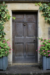 Wooden front door of a traditional English cottage house
