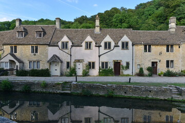 view of old terraced houses by a river in a beautiful village