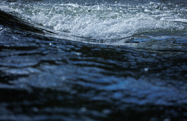 Flowing blue fresh water in river