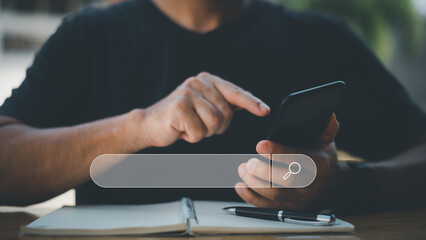 Search technology, search engine optimization,man's hand using laptop computer keyboard to search information,using search engine bar function on your website.People who work in cafes