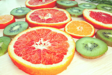 Fototapeta na wymiar Bright citrus fruits cut into rings. Side view. Blurred background.