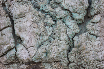Weird stone texture with cracks, fissures, and leaks. Abstract patterned background