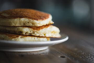 Short Stack of Pancakes on Wooden Table in Morning Light. Cooking Breakfast Lifestyle. 