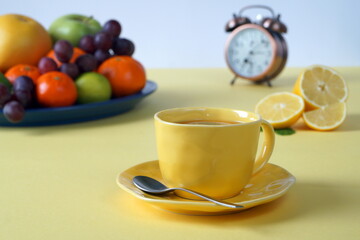 Breakfast of a person who cares about his health - fruit, a hot drink. Yellow background for a great sunny morning