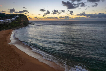 Breezy aerial sunrise seascape with clouds