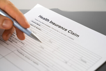 Hand Filling Health Insurance Claim Form