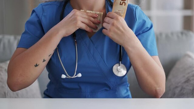 Medical tax. Health insurance. Illegal profit. Unrecognizable dishonest greedy female doctor counting stealing money hiding 50 bill Euro cash banknote.