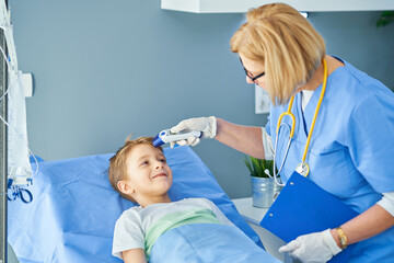 Adult woman and young patient in hospital bed