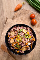 Fried purple rice with tofu, carrot, pumpkin and chili pepper. Healthy Asian vegan food, Table top view