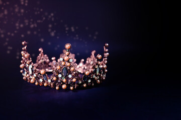 Beautiful golden queen crown in dark key with glow