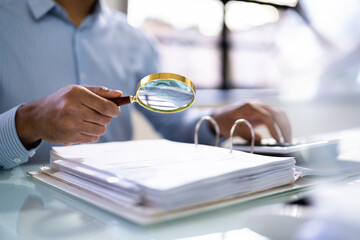 Auditor Using Magnifying Glass For Audit