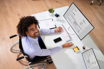 African Accountant With Disability Working On Computer