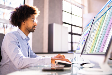 Data Analyst African Man Using Spreadsheet